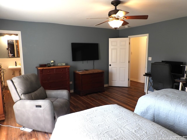 bedroom with ensuite bath, dark wood-type flooring, and ceiling fan