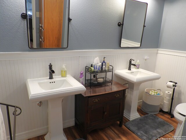 bathroom featuring sink, hardwood / wood-style flooring, and toilet