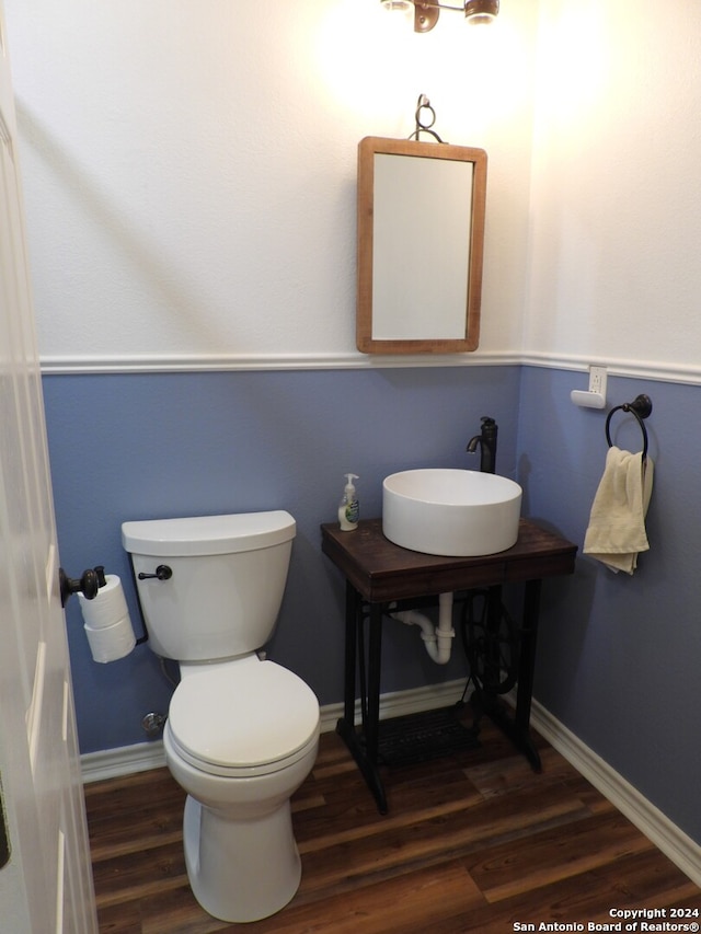 bathroom featuring sink, wood-type flooring, and toilet