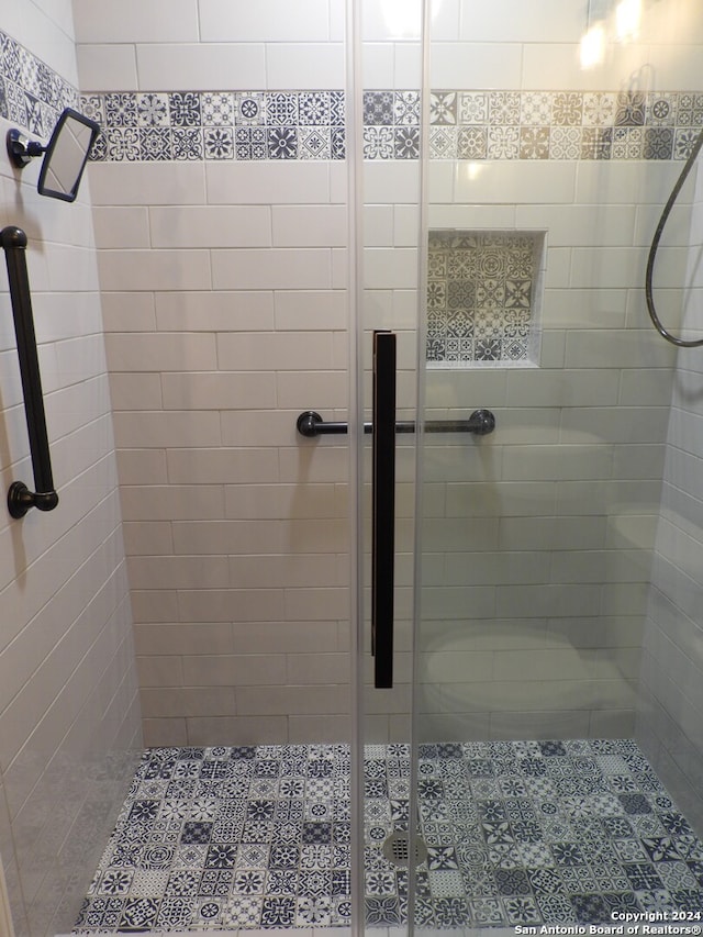 bathroom featuring a shower with shower door