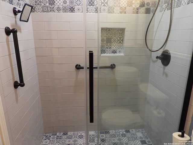 bathroom with a shower with door