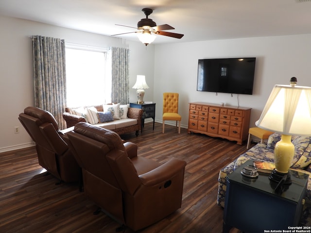 living room featuring dark wood-type flooring and ceiling fan