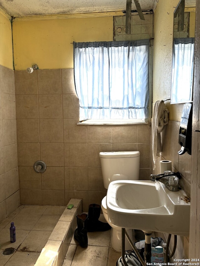 bathroom with toilet, a textured ceiling, and tile patterned flooring