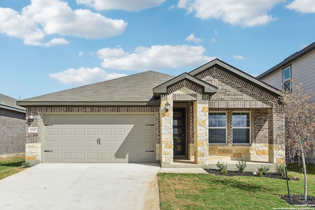 view of front of home with a front lawn and a garage