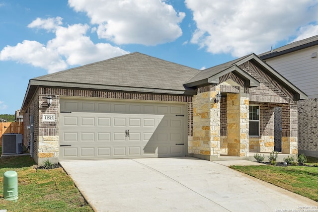 view of front of house featuring central AC and a garage