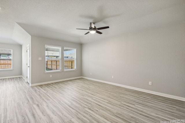 spare room with light hardwood / wood-style floors, a textured ceiling, and ceiling fan