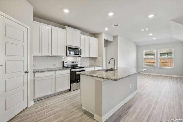 kitchen with sink, appliances with stainless steel finishes, light hardwood / wood-style flooring, and white cabinetry