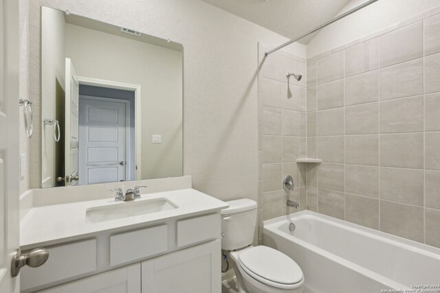 full bathroom featuring vanity, toilet, and tiled shower / bath