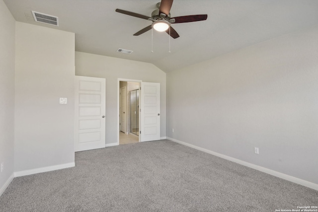 spare room with vaulted ceiling, light carpet, and ceiling fan