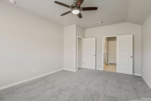 unfurnished bedroom featuring vaulted ceiling, light carpet, and ceiling fan