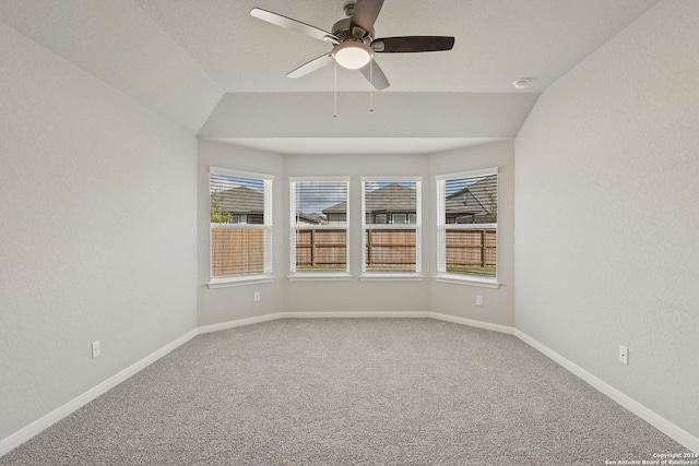 carpeted empty room featuring ceiling fan and vaulted ceiling