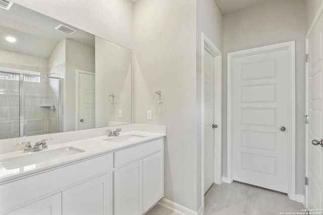 bathroom featuring vanity and an enclosed shower