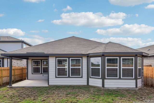 back of house with a yard and a patio area