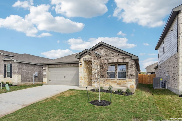 view of front of property with a front yard, central AC, and a garage