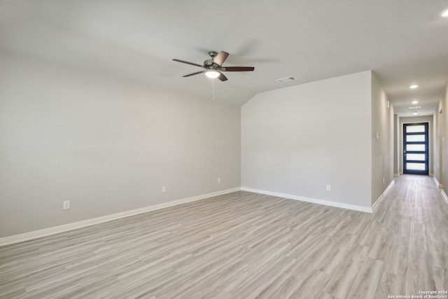 unfurnished room featuring light hardwood / wood-style flooring, vaulted ceiling, and ceiling fan