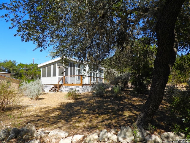 exterior space featuring a deck and a sunroom