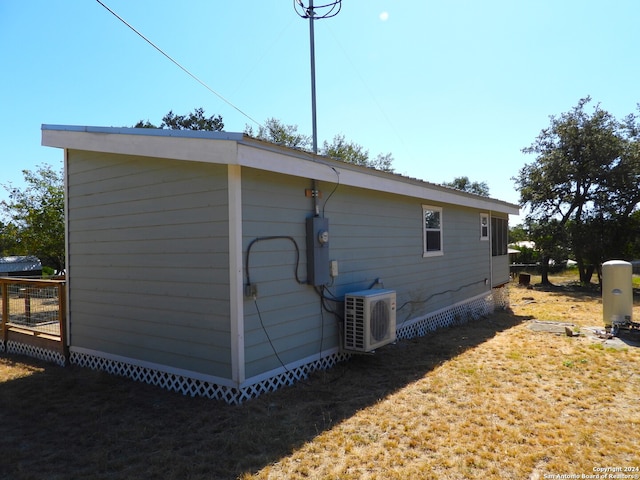 view of home's exterior featuring a yard and ac unit