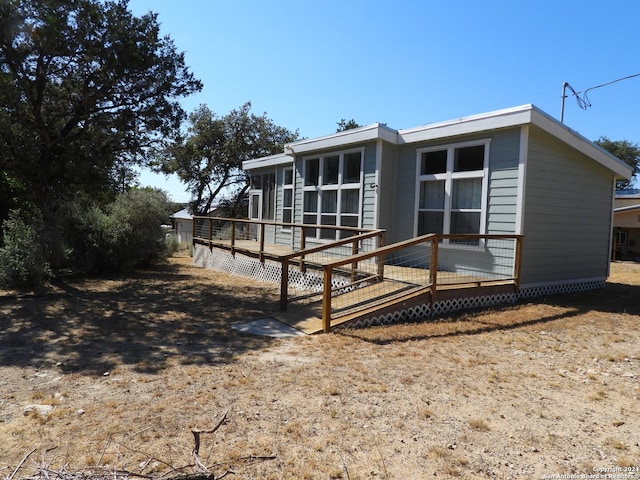 back of house with a wooden deck