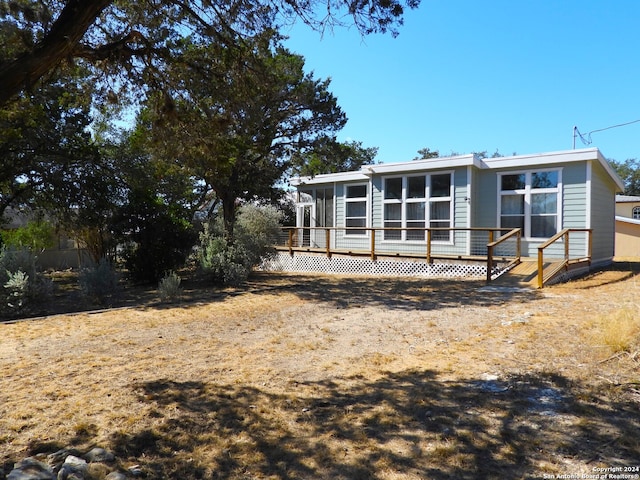 back of property with a wooden deck