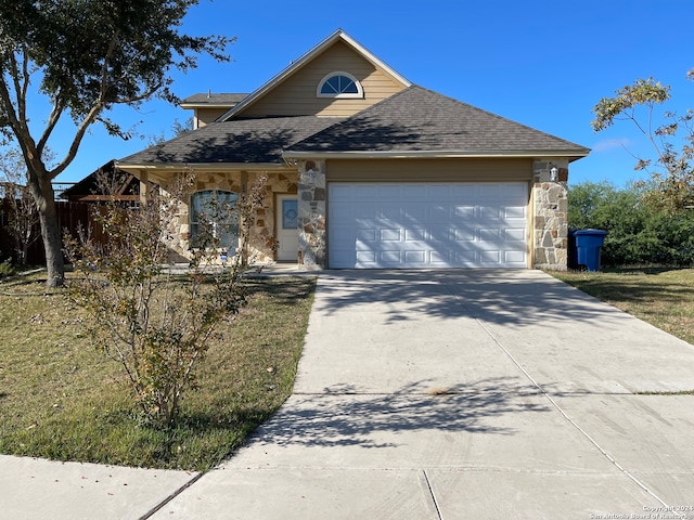 view of front of house with a garage and a front lawn