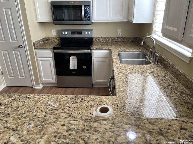 kitchen featuring white cabinetry, stainless steel appliances, sink, and dark hardwood / wood-style flooring