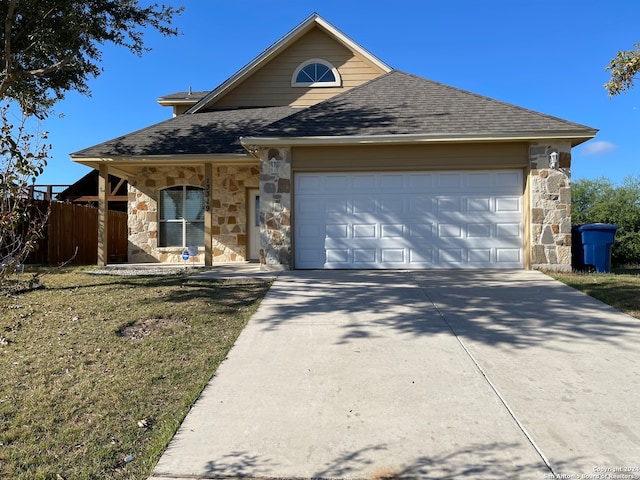 view of front of home featuring a front yard and a garage