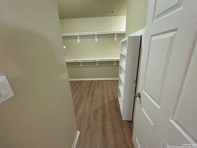 spacious closet featuring hardwood / wood-style flooring