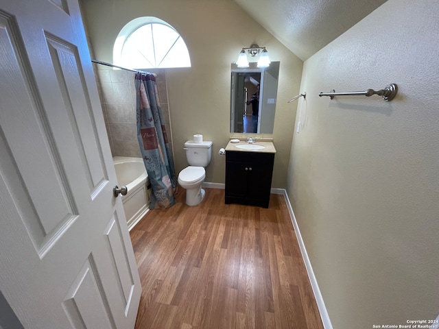 full bathroom with toilet, shower / bath combination with curtain, hardwood / wood-style floors, vaulted ceiling, and vanity