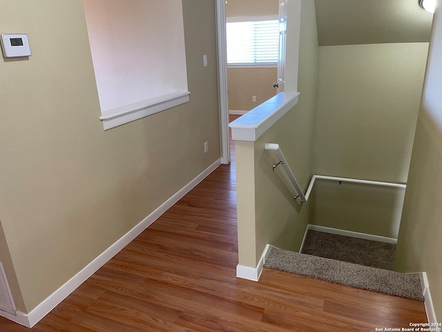 stairway featuring hardwood / wood-style floors