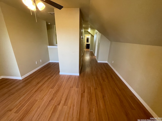 bonus room featuring lofted ceiling, hardwood / wood-style flooring, and ceiling fan