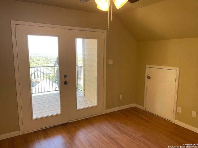 entryway featuring ceiling fan, hardwood / wood-style flooring, vaulted ceiling, and plenty of natural light