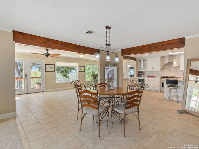 dining area featuring beamed ceiling, crown molding, french doors, and ceiling fan