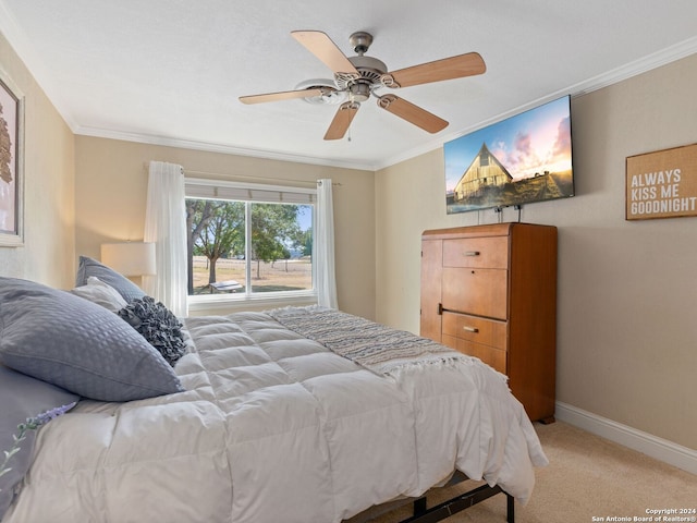 carpeted bedroom featuring crown molding and ceiling fan