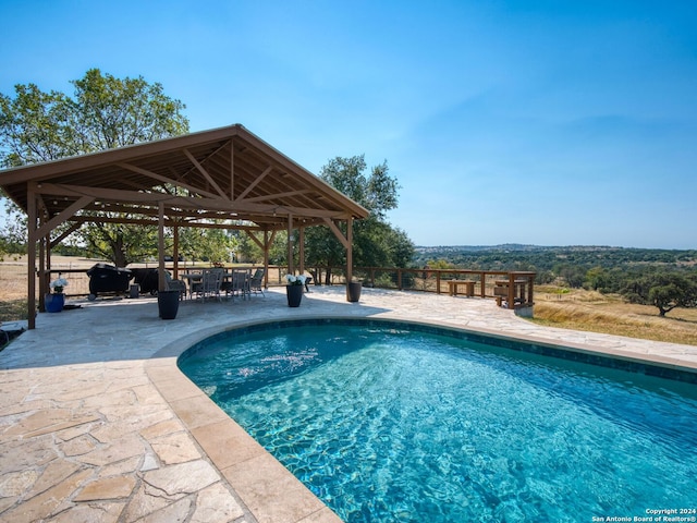 view of swimming pool with a gazebo and a patio area