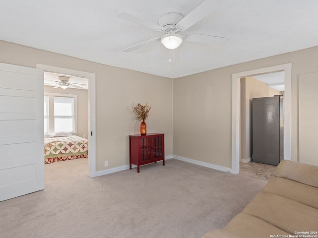 sitting room with light colored carpet and ceiling fan