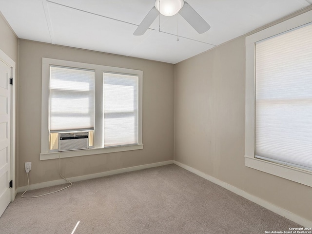 spare room featuring cooling unit, light carpet, and ceiling fan