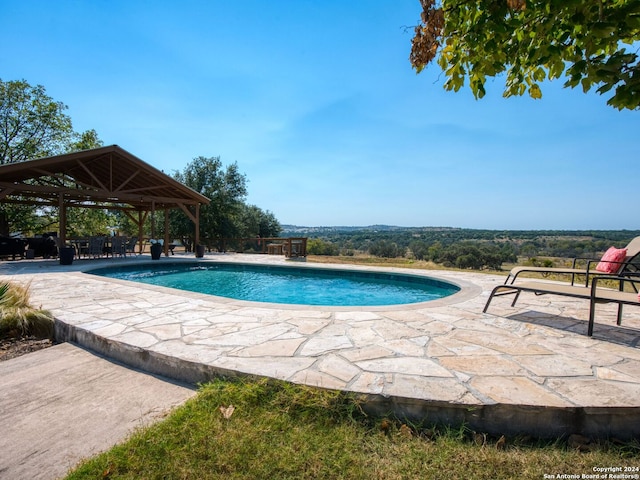 view of swimming pool with a patio and a gazebo