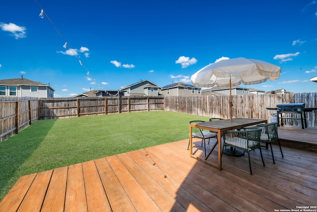 wooden terrace with a lawn