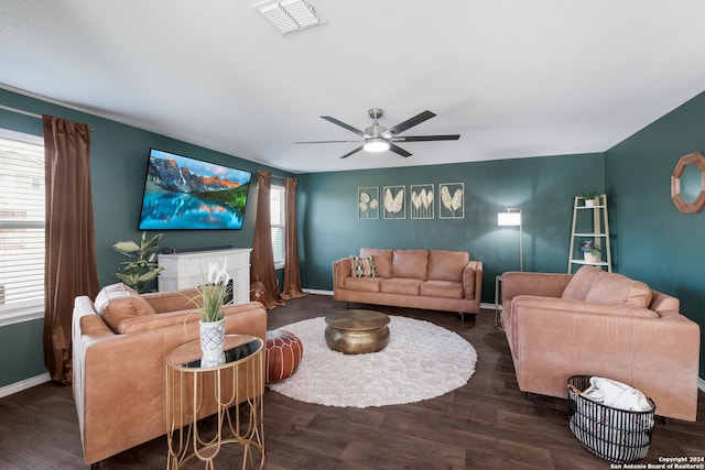 living room featuring ceiling fan and dark hardwood / wood-style flooring