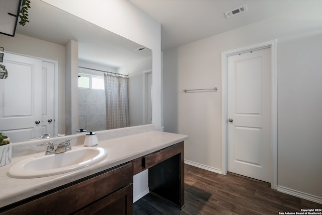 bathroom featuring vanity, hardwood / wood-style floors, and curtained shower