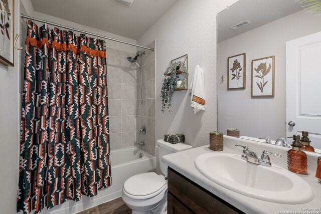 full bathroom with vanity, shower / tub combo with curtain, toilet, and hardwood / wood-style flooring