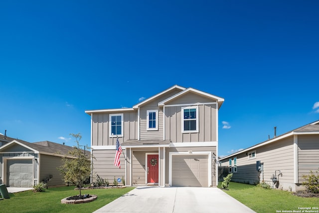 view of front of home featuring a front lawn and a garage