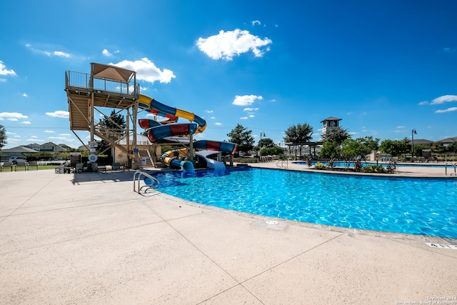 view of swimming pool featuring a patio and a water slide