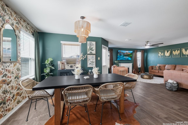 dining area with ceiling fan and wood-type flooring