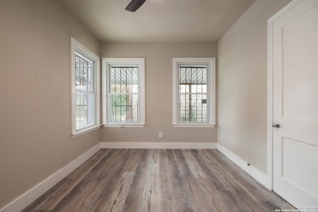 spare room with ceiling fan and wood-type flooring