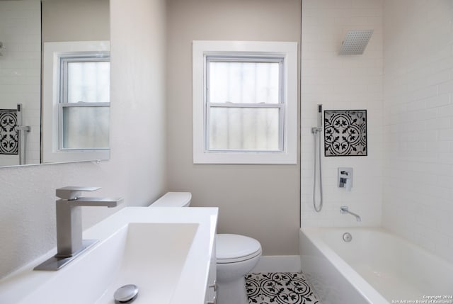 full bathroom featuring vanity, tiled shower / bath combo, toilet, and tile patterned flooring