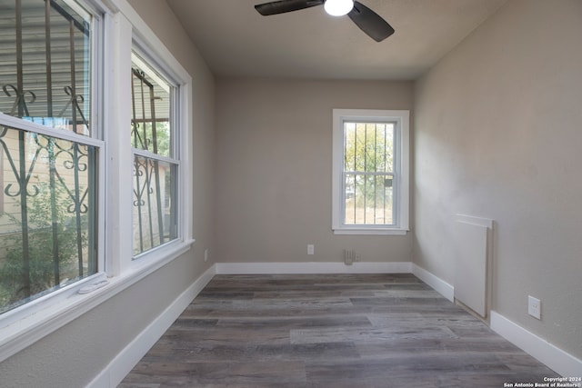 spare room with dark hardwood / wood-style floors and ceiling fan