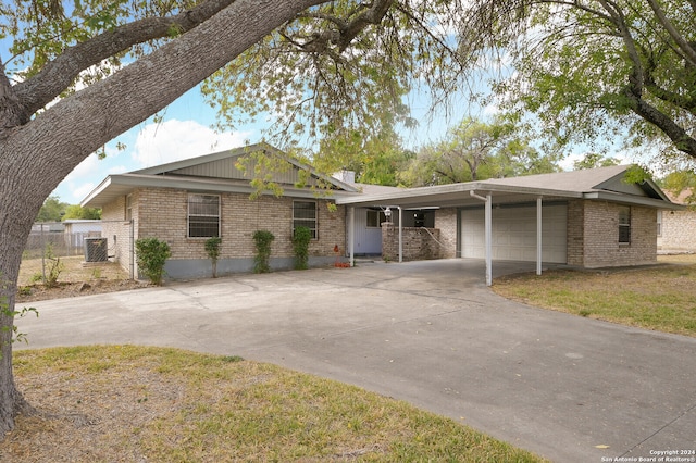 view of front of house with cooling unit, a garage, and a carport