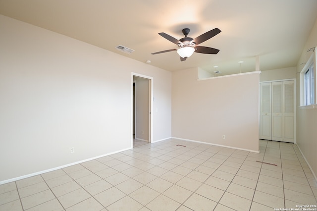 tiled empty room with ceiling fan