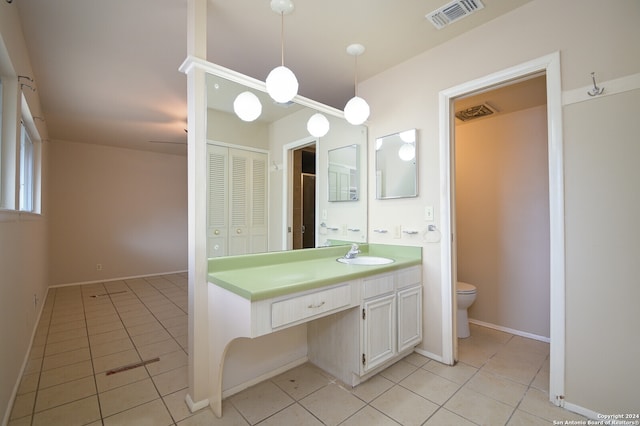 bathroom featuring toilet, vanity, and tile patterned floors